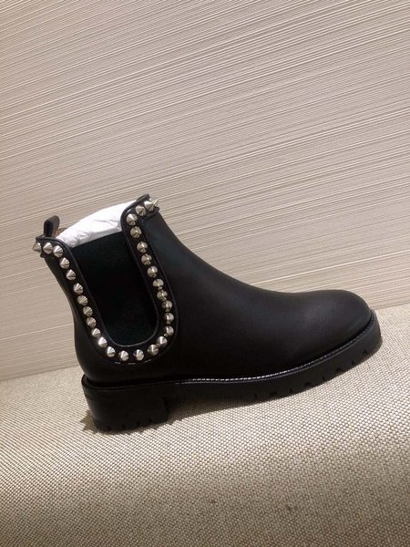 Christian Louboutine Black platform rivet boots.